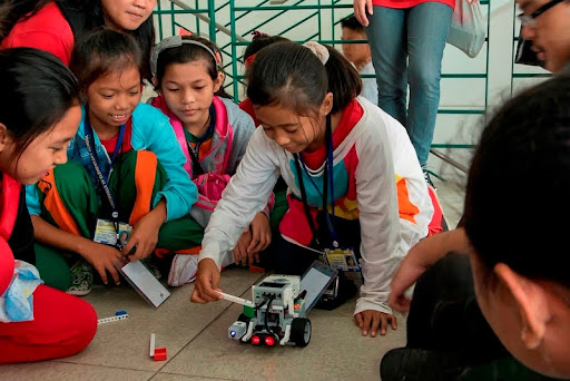 children playing with robot model