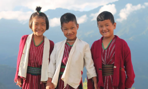 three children on a mountainside